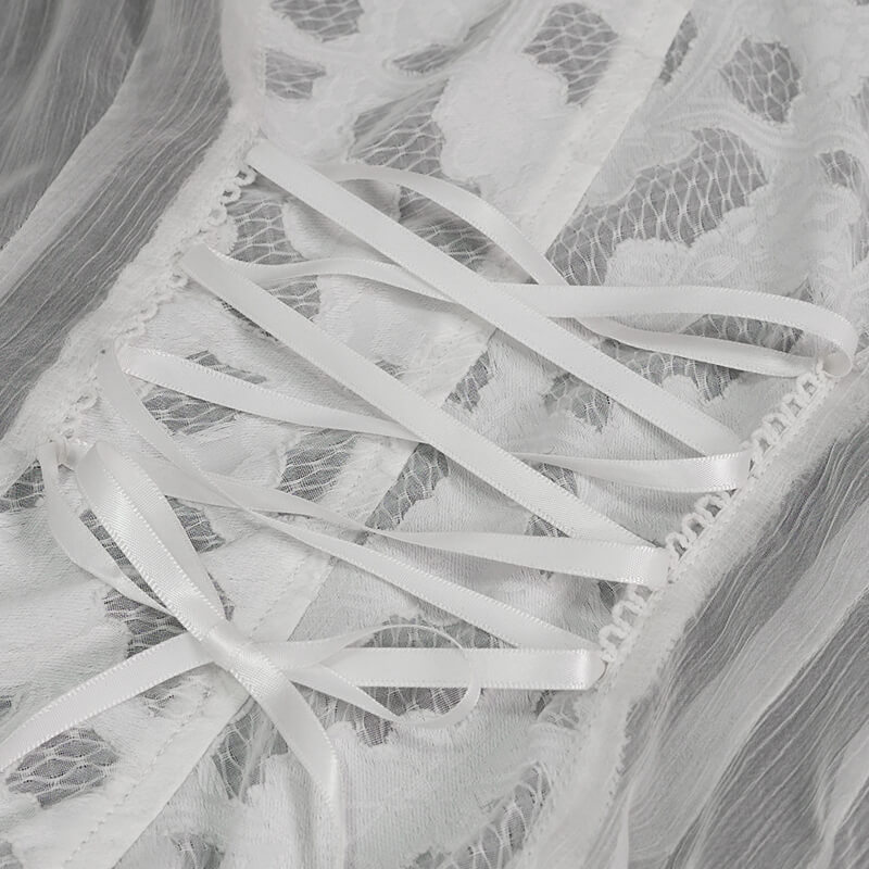 Close-up of vintage white chiffon lace detailing with elegant ribbons on a ladies blouse.