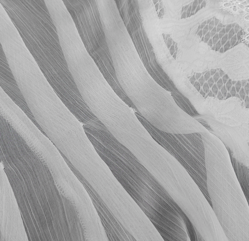 Close-up of vintage chiffon fabric with lace inserts, perfect for a stylish ladies' blouse.