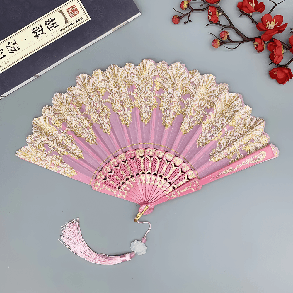Vintage Chinese Lace Folding Fan with Tassel Detail in pink, featuring intricate floral design and ornate detailing.