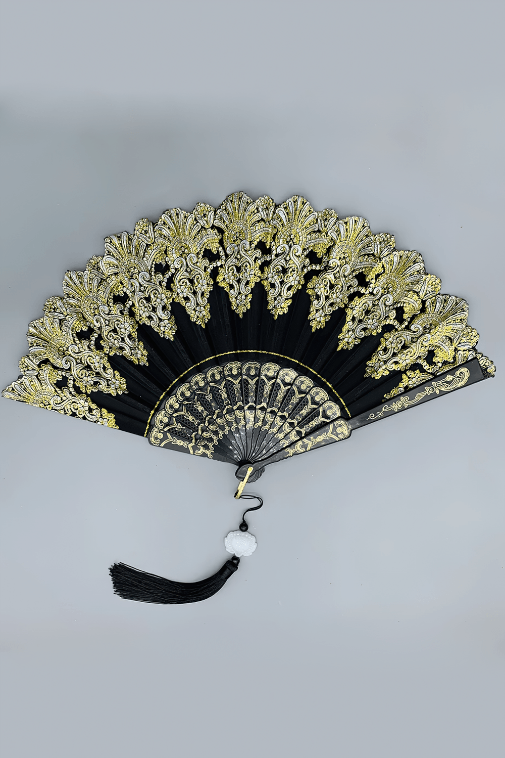 Vintage Chinese Lace Folding Fan with Tassel Detail in black and gold, intricate floral design with tassel, perfect for gothic outfits.