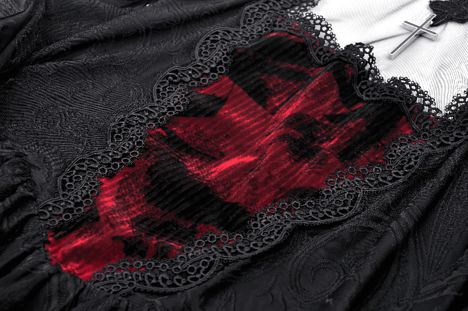 Close-up of vintage gothic dress featuring burgundy velvet inset and intricate black lace detailing.