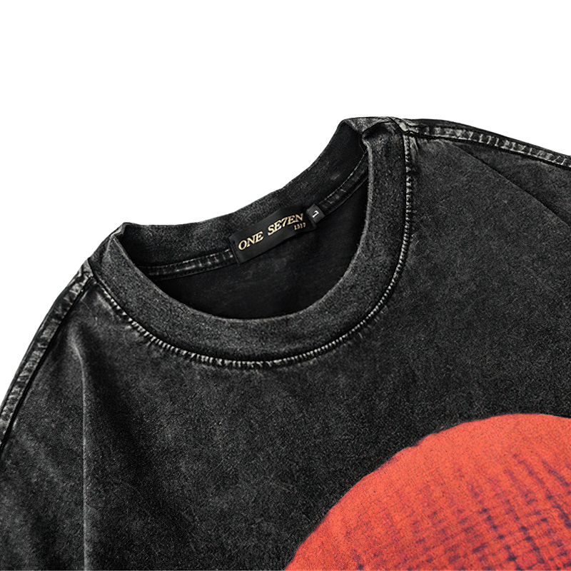 Close-up of a vintage black cotton t-shirt featuring a unique printed design and tag detail.