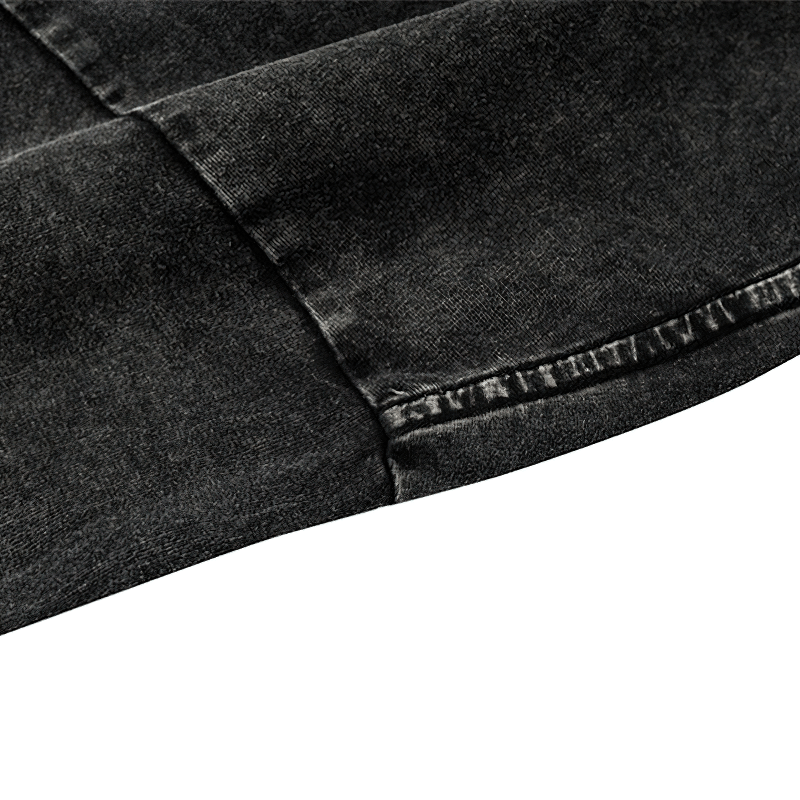 Close-up of a vintage black cotton t-shirt sleeve showing the unique texture and stitching details.