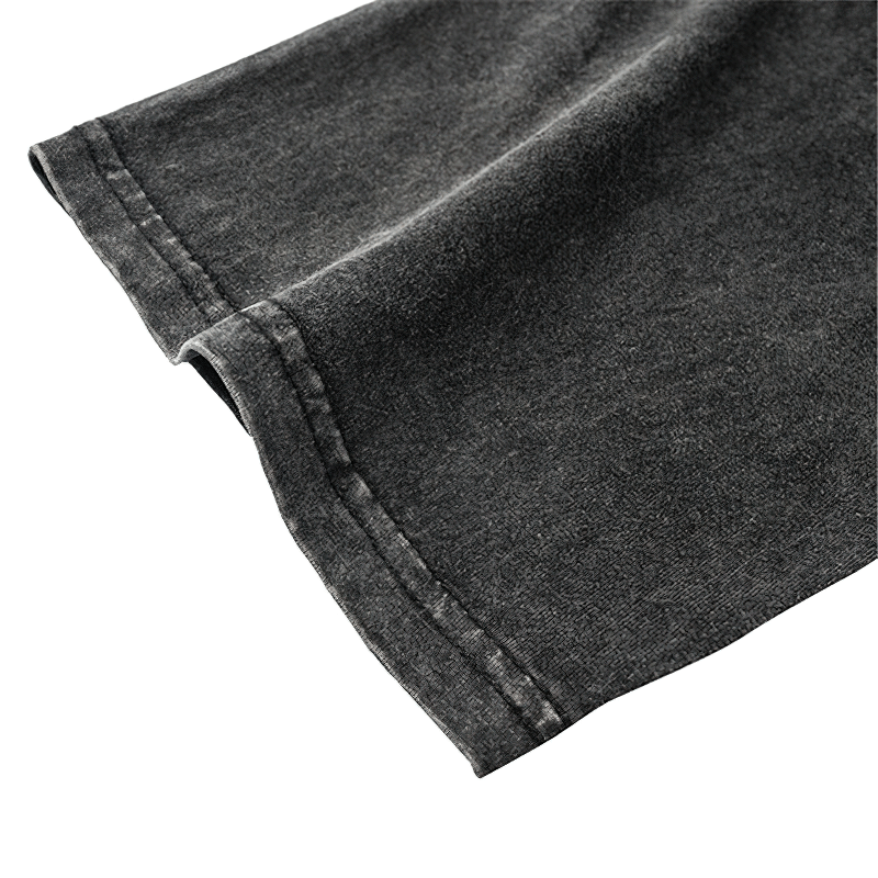 Close-up of the sleeve of a vintage black cotton T-shirt showcasing quality stitching and soft fabric texture.