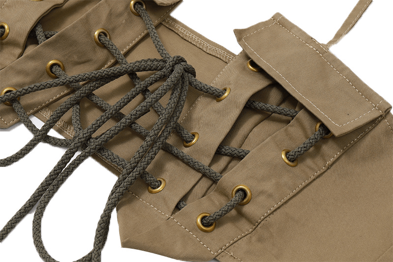 Close-up of vintage cross lace-up design with gold eyelets and braided cords on a stylish off-shoulder top.