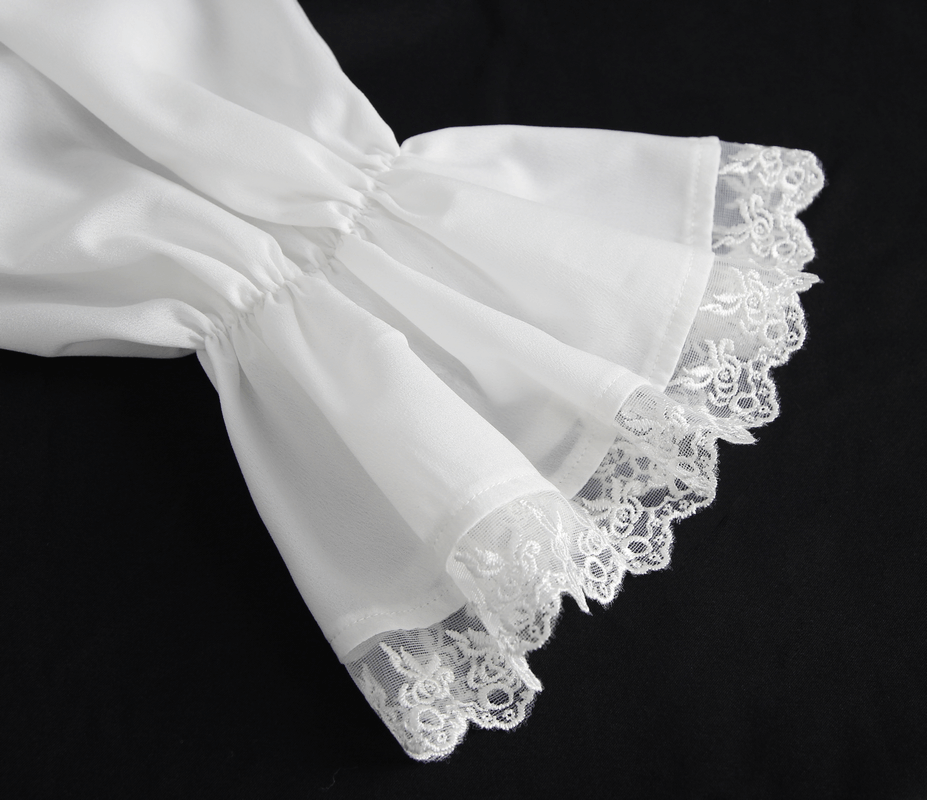 Close-up of a white shirt's ruffle sleeves with delicate lace trim, adding vintage charm and elegance.