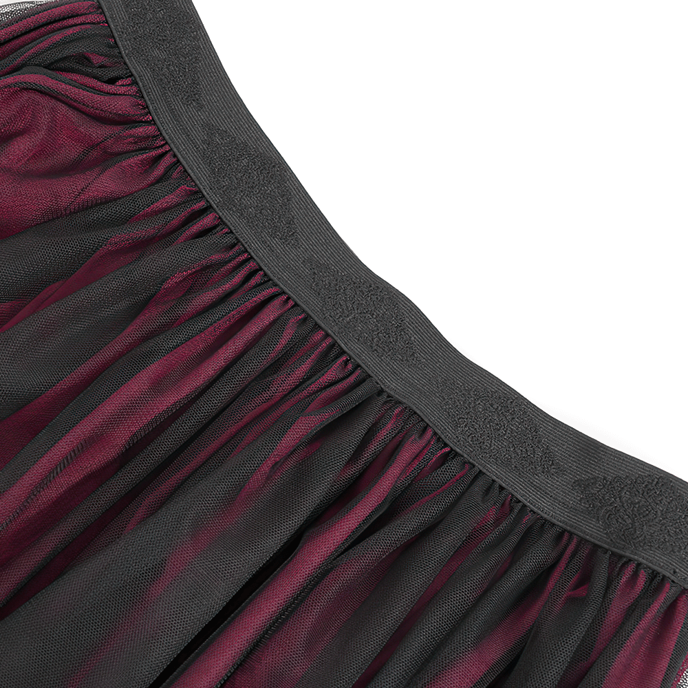 Close-up of the elastic waistline of a vintage gothic wine red mesh maxi skirt with delicate embroidery.