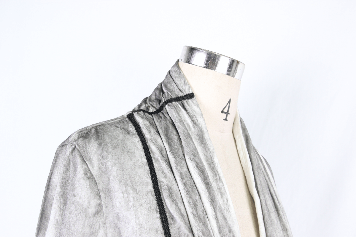 Elegant gray velvet jacket with black trim, perfect for a stylish vintage look on a dress form.