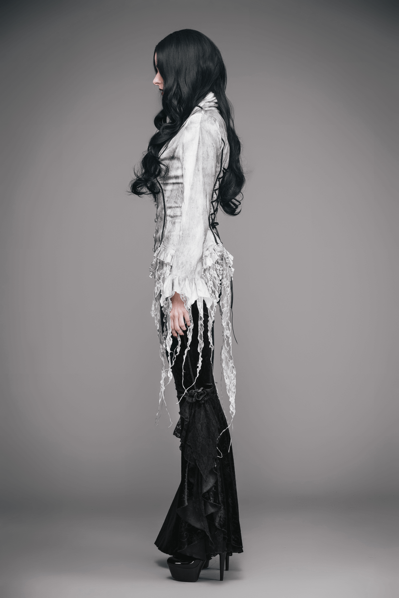 Elegant white deep V blouse for women with gothic style, paired with flowing black pants and long dark hair.