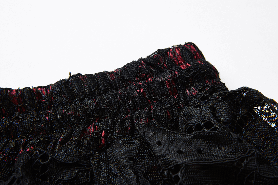 Close-up of the waistband of a vintage black lace maxi skirt with ruffles, showcasing intricate lace details.