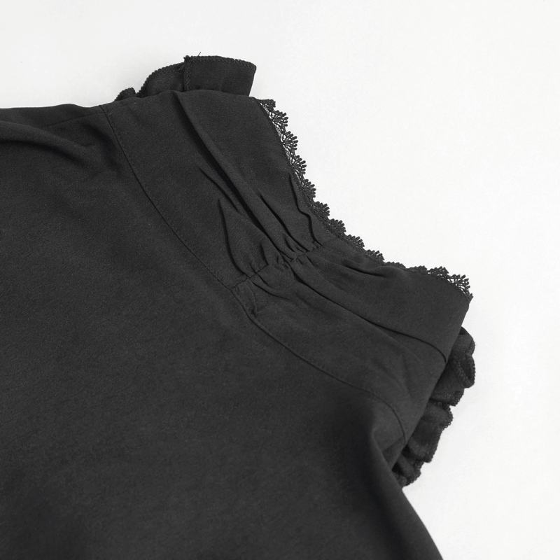 Close-up of ruffled cuffs on a vintage black men's shirt, showcasing delicate frills and soft fabric.