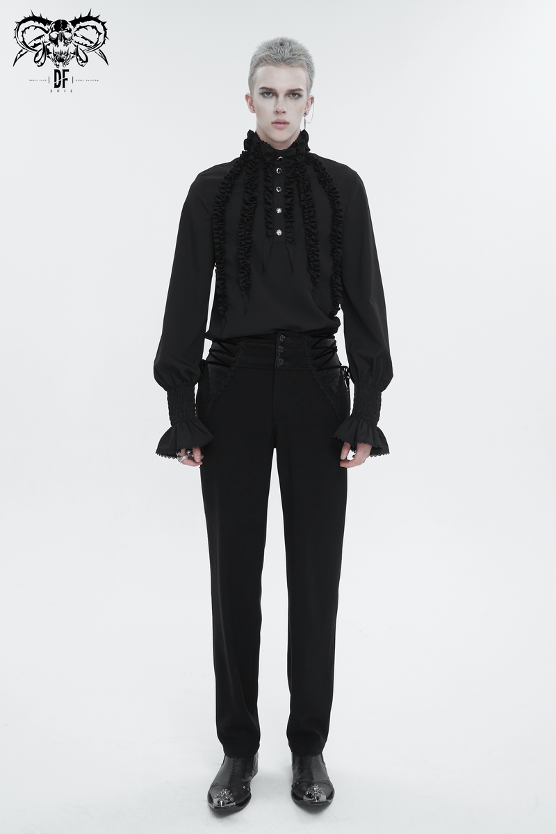 Stylish black vintage shirt with frilly long sleeves and ruffled cuffs, worn with sleek black pants for a bold fashion statement.
