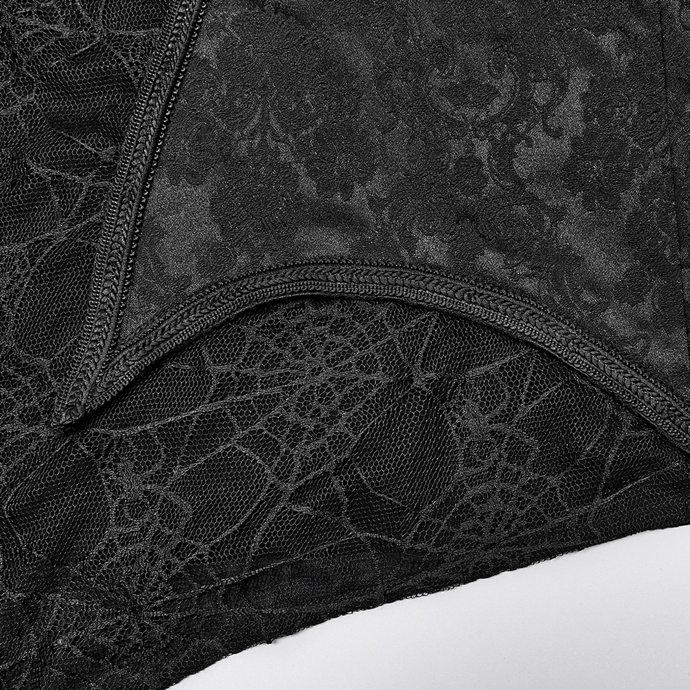 Close-up of black jacquard fabric with spider web design, showcasing vintage gothic lace details.