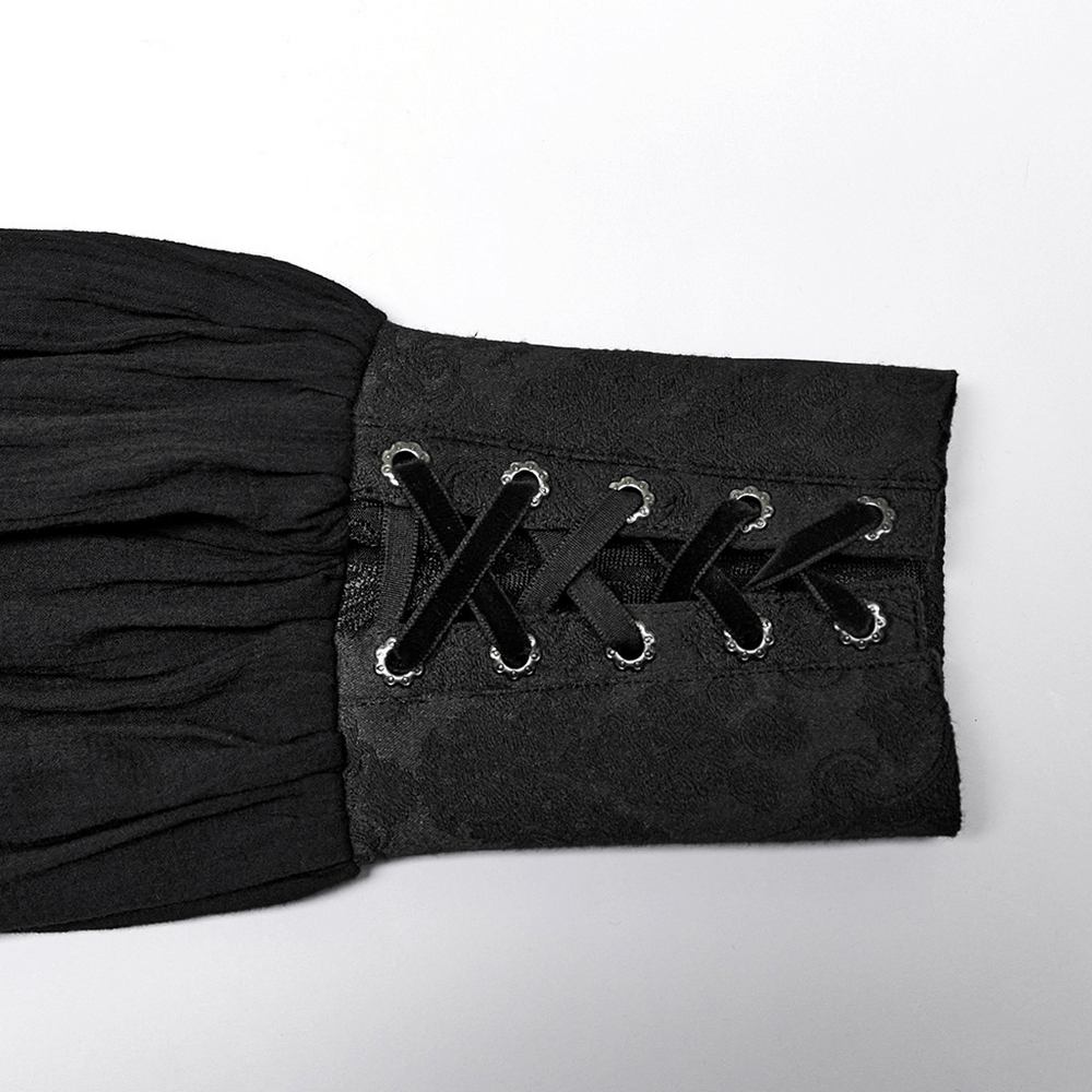 Close-up of the gothic button-up shirt's lace-up cuff detail in black jacquard fabric.