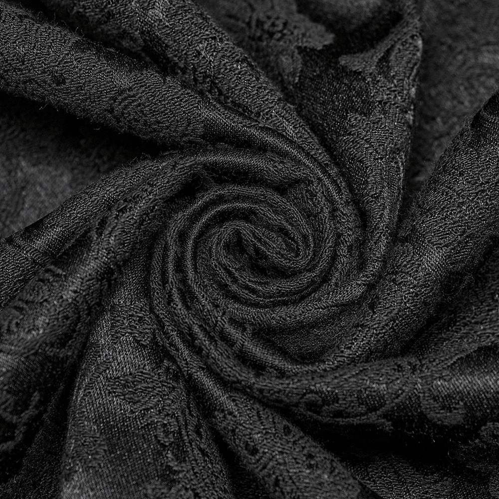 Close-up of luxurious black jacquard fabric showcasing intricate textures and gothic flair.