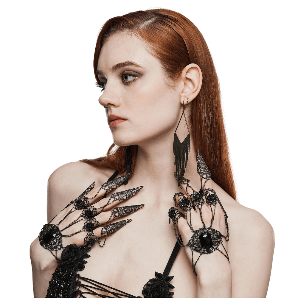 Vintage gothic finger bracelet with tassels and rose buckles, enhancing dark elegance and bold style.