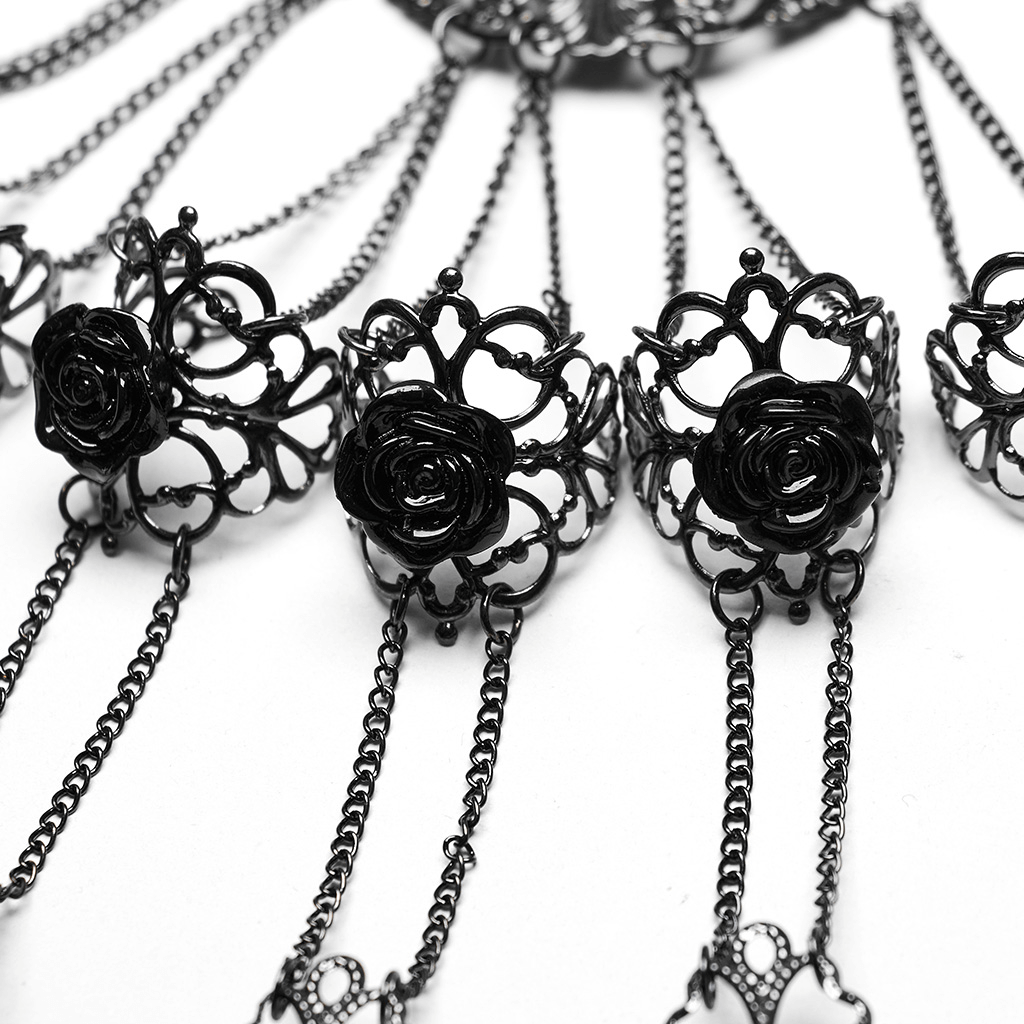 Elegant vintage gothic finger bracelet featuring black rose buckles and tassel details for a bold statement.