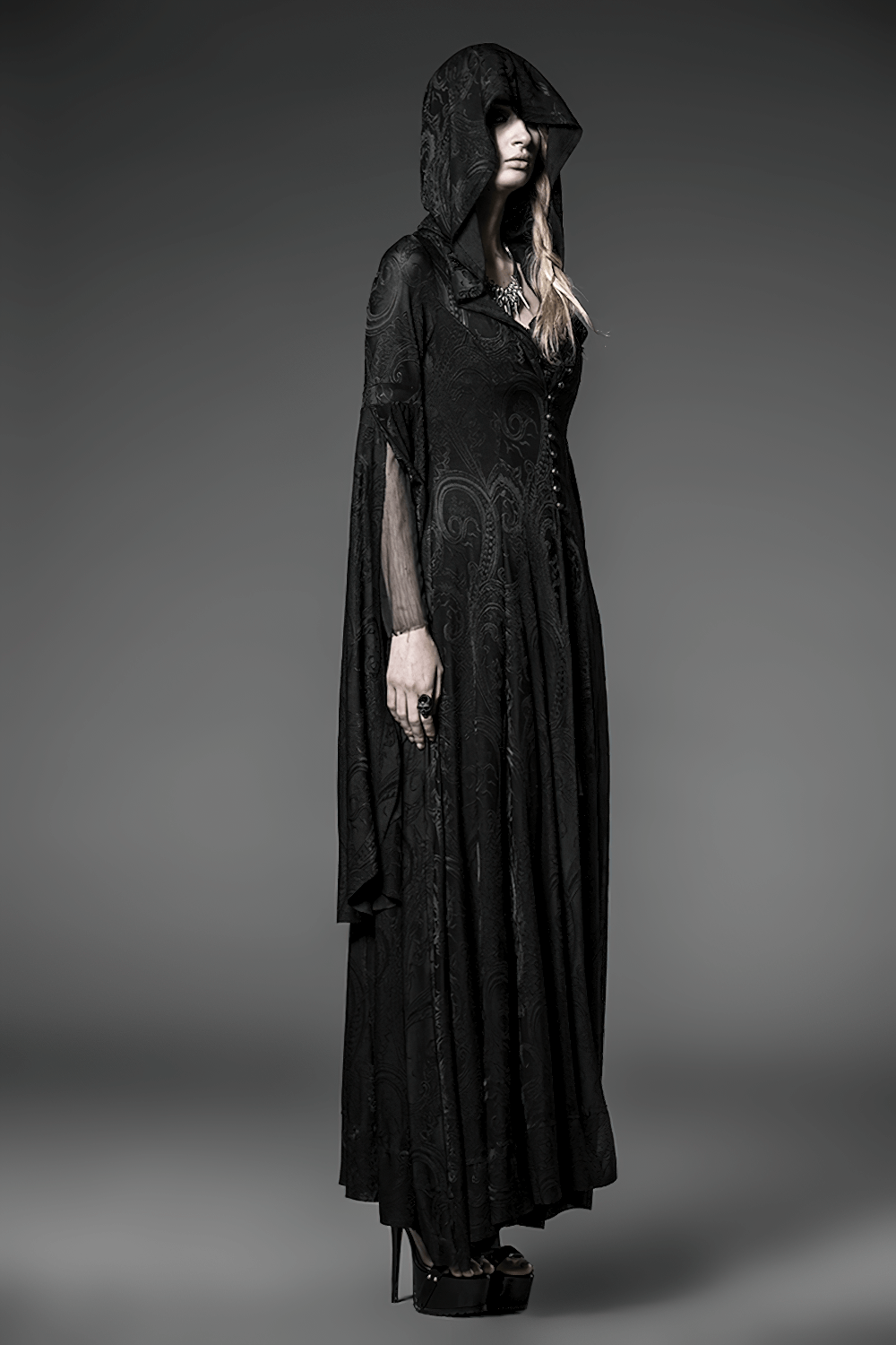 Elegant vintage gothic hooded cape for women, showcasing long sleeves and intricate embroidery in a mystical setting.