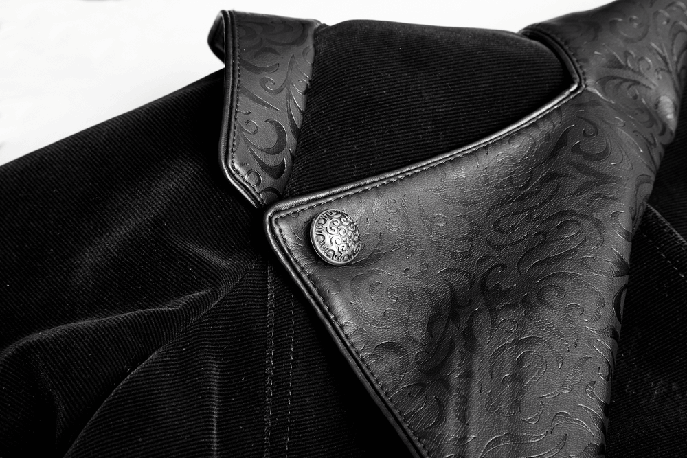 Close-up of vintage gothic male cloak showcasing velvet and ornate leather collar with button detail.