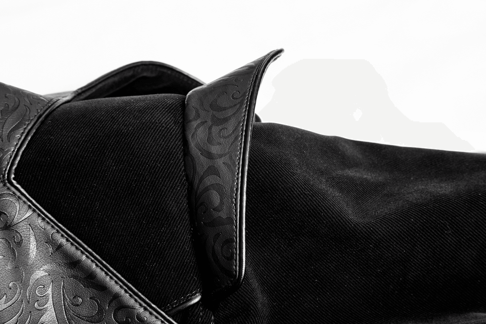 Close-up of the elegant leather collar on a vintage gothic velvet cloak, showcasing intricate designs.
