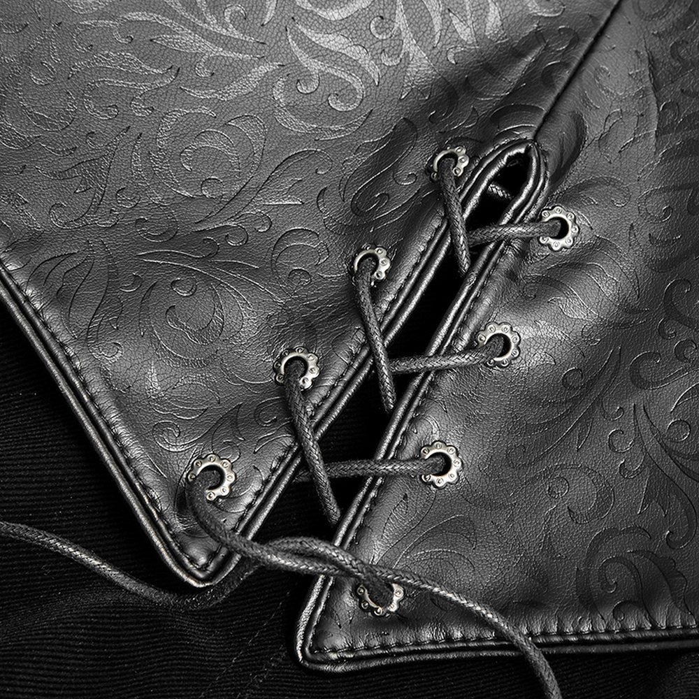 Close-up of ornate black leather accents and lacing on a vintage gothic cloak, showcasing intricate design.