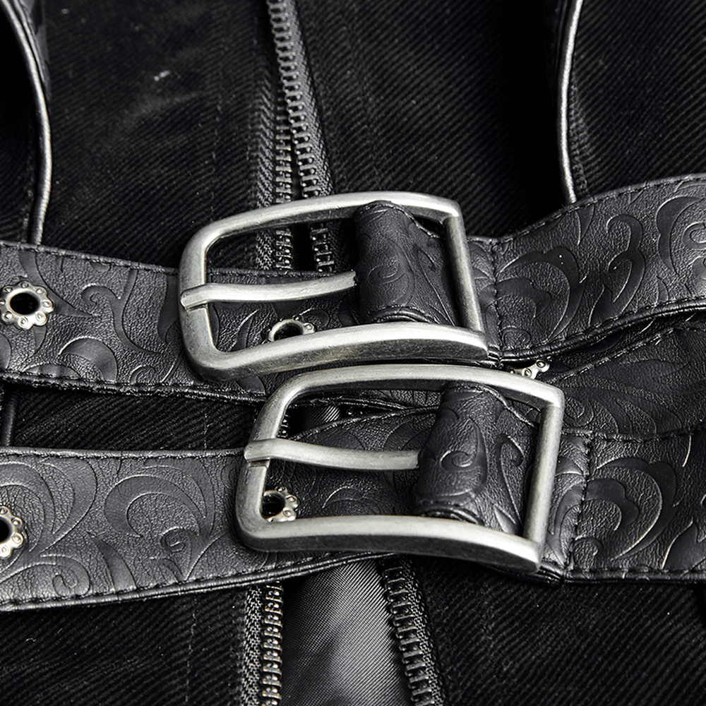 Close-up of vintage leather accents and buckles on a gothic velvet cloak, showcasing exquisite craftsmanship.