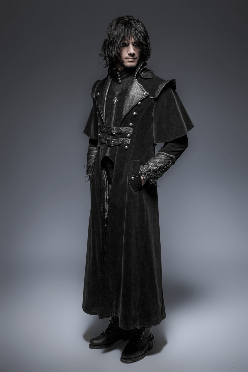 Gothic male model wearing a vintage velvet cloak with leather accents, exuding a cool gothic vibe.