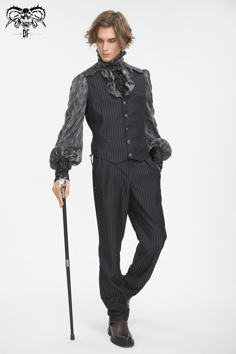 Man wearing vintage gothic pinstriped waistcoat with stylish shirt and cane, exuding elegance.