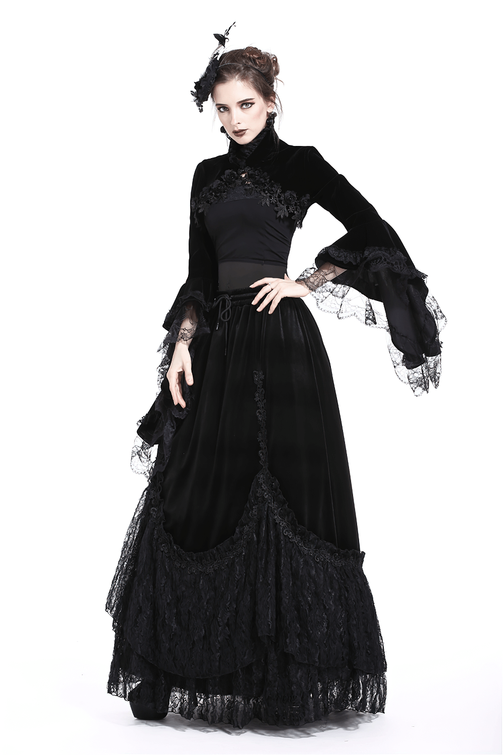 Elegant model wearing a Vintage Gothic Velvet Bolero with lace sleeves, showcasing a dramatic black lace outfit.