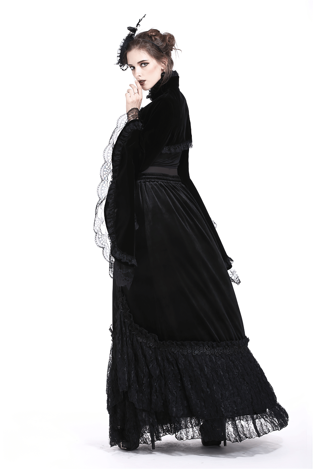 Elegant woman in black vintage gothic velvet bolero with lace sleeves, embodying Victorian charm.
