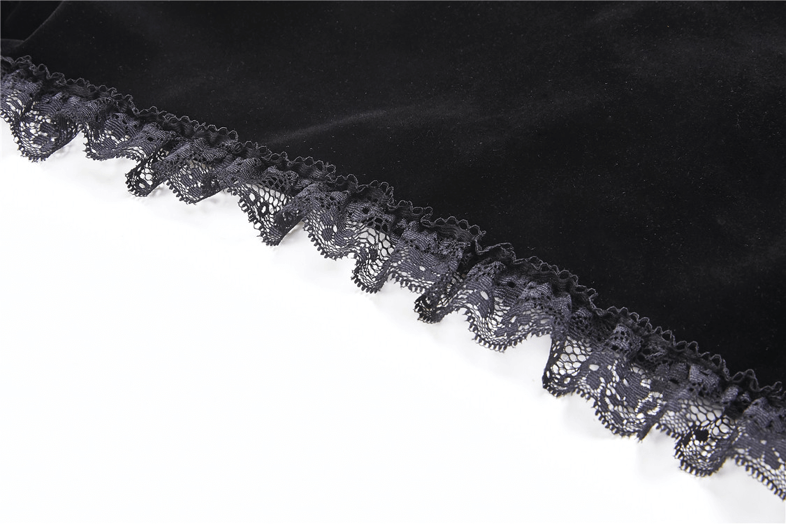 Close-up of black velvet fabric with delicate lace trim, perfect for Gothic style bolero.