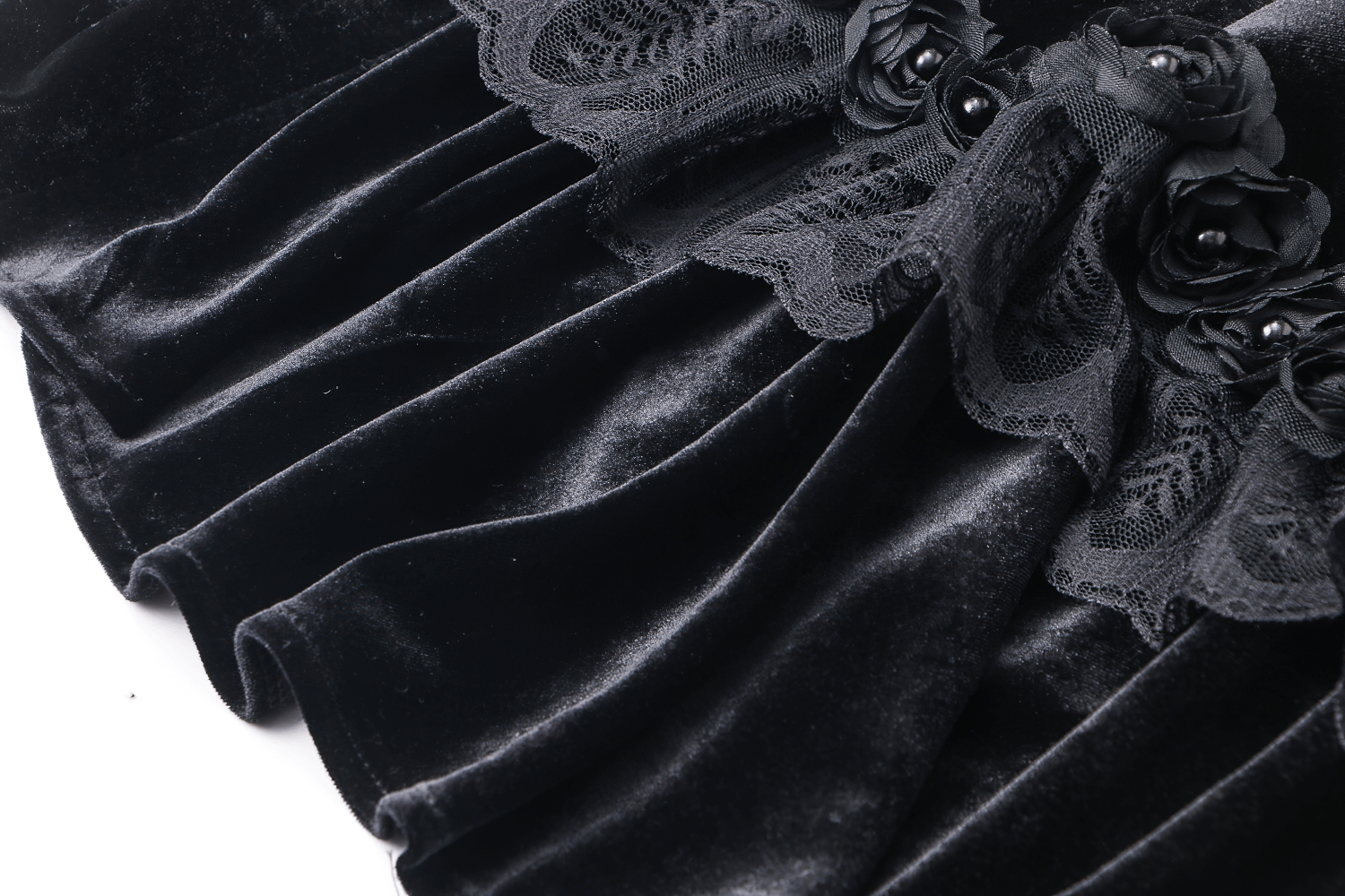 Close-up of a vintage gothic velvet capelet with lace trim and black roses, perfect for dark romantic outfits.