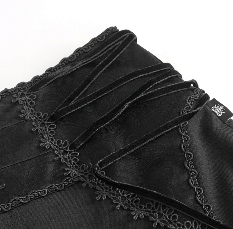 Close-up of vintage high-waisted gothic pants showcasing intricate lace-up waist detail and patterned fabric.