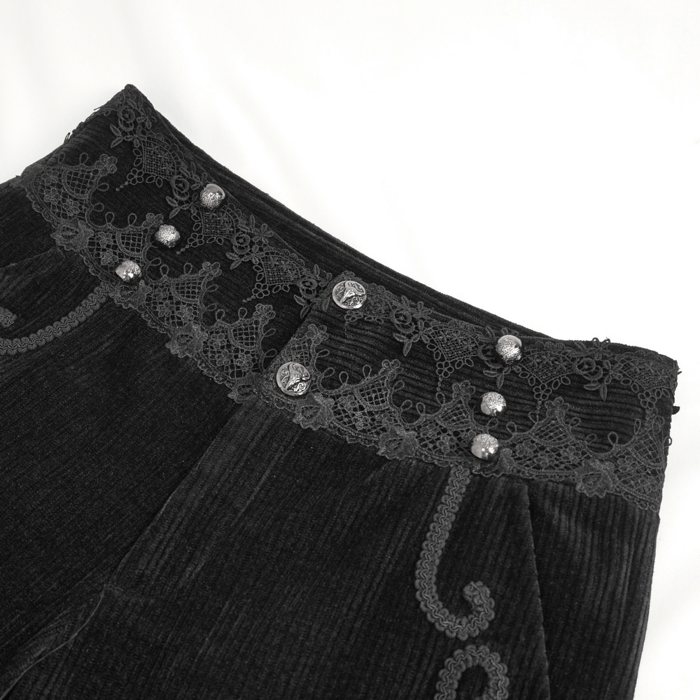 Close-up of Retro Noir black corduroy pants showcasing lace trim and detailed button design.