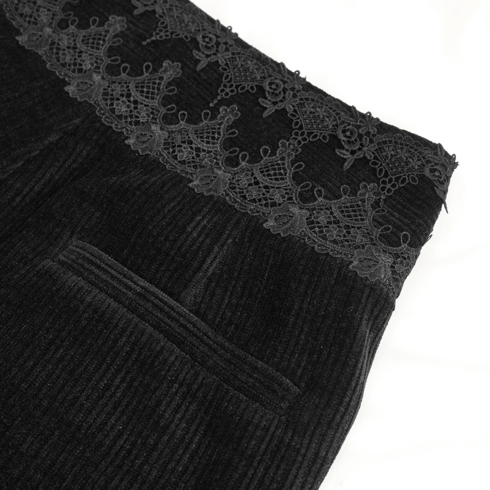 Close-up of vintage-inspired black corduroy pants featuring elegant lace trim detail.