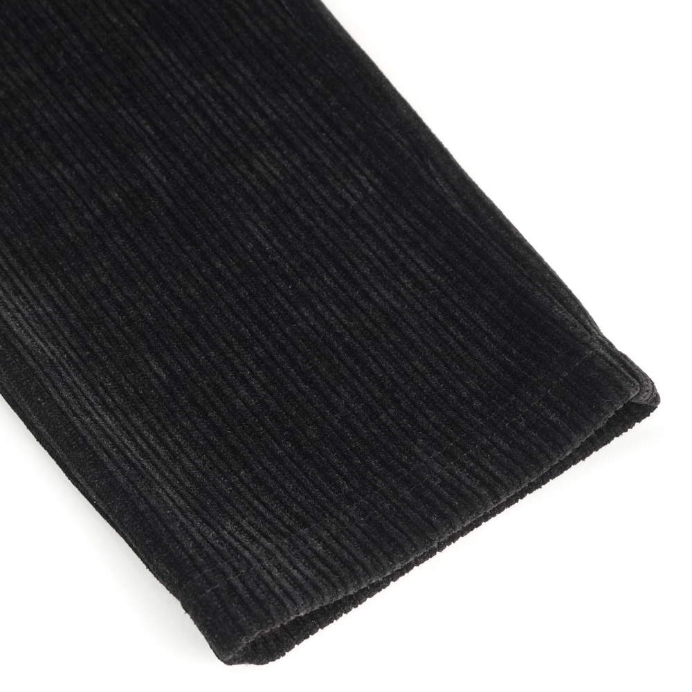 Close-up of black corduroy fabric showcasing soft ribbed texture for vintage-inspired pants.