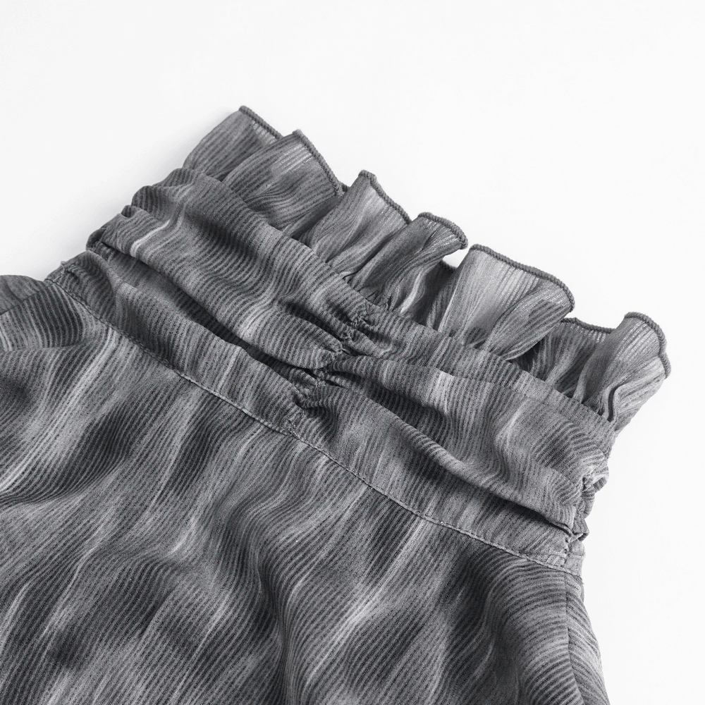 Close-up of the ruffled neckline of a vintage-inspired gothic shirt in textured fabric.