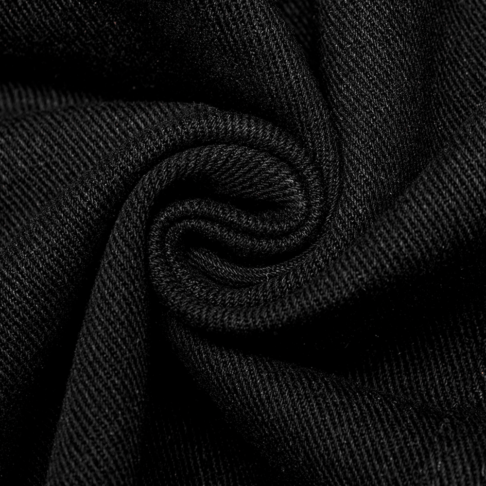 Close-up of textured black fabric with a swirling pattern, showcasing quality material for a vintage-inspired jacket.