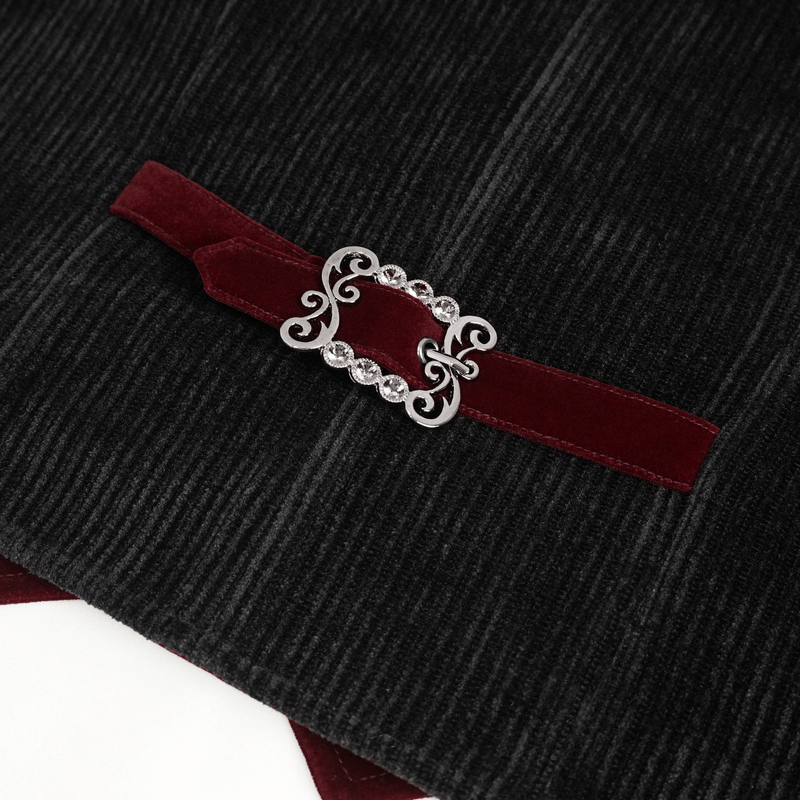 Close-up of vintage velvet waistcoat detail showcasing a decorative button and rich burgundy ribbon accent.
