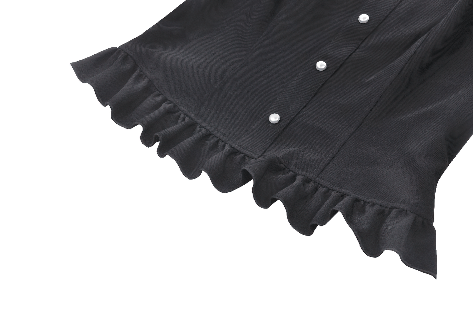 Close-up of a black blouse with ruffled hem and pearl buttons, showcasing vintage elegance in women's fashion.