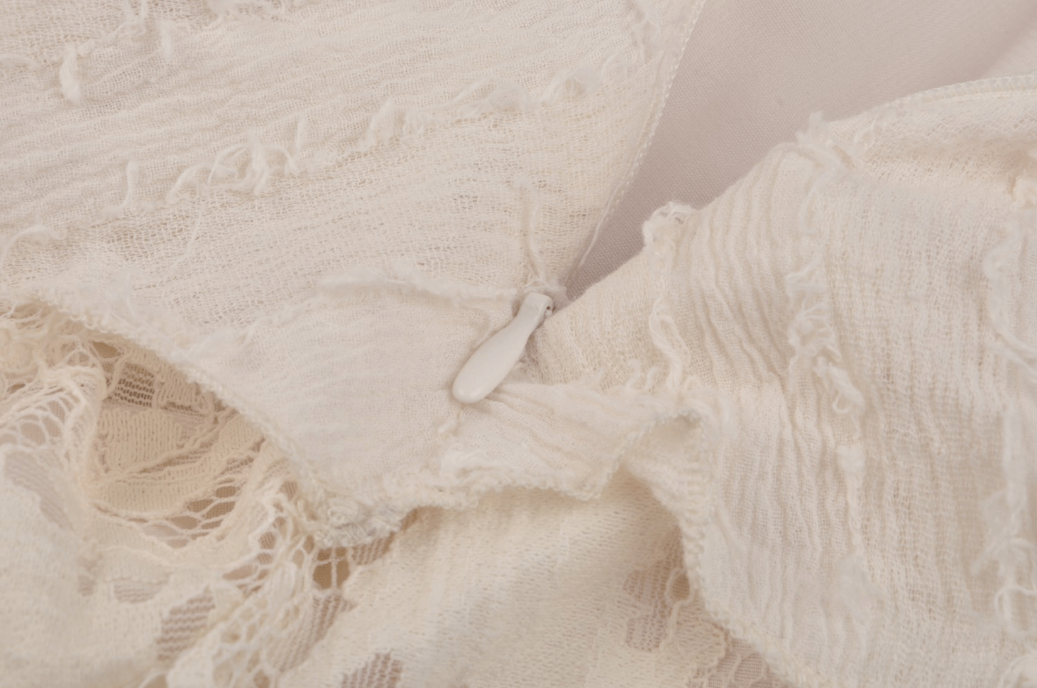 Close-up of the delicate lace and ruffled detailing on a vintage-inspired dress.