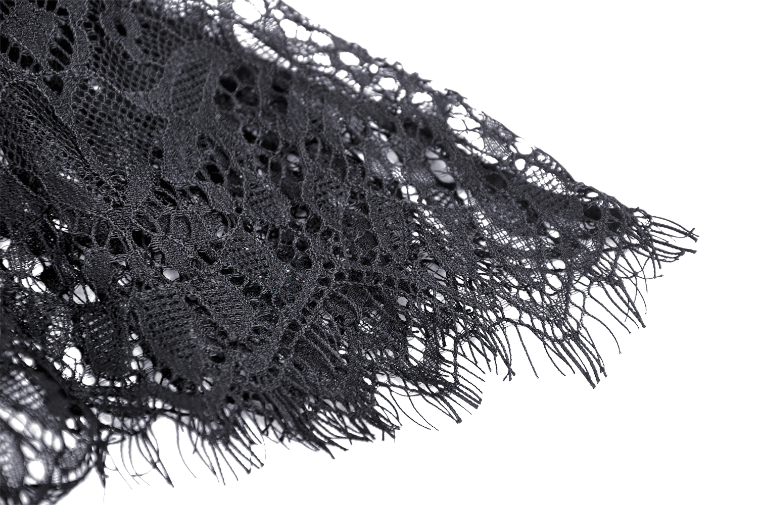 Close-up of delicate black lace with intricate floral designs and fringed edges, perfect for vintage skirts.