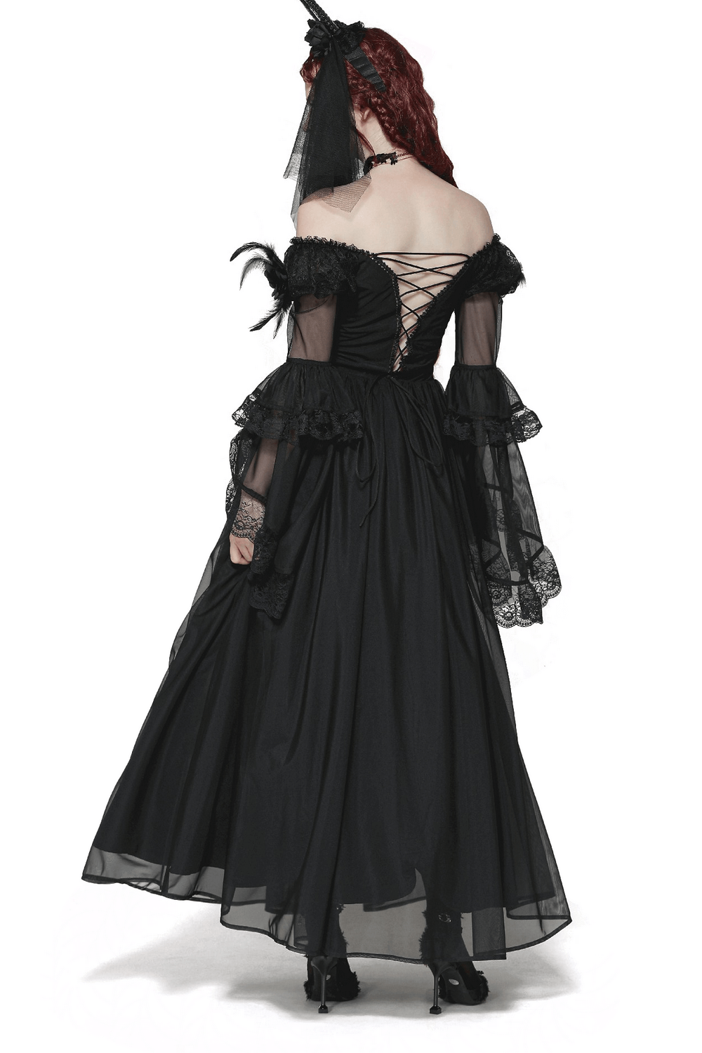 Rear view of a vintage lace-up Gothic dress with dramatic lace sleeves and feather details.