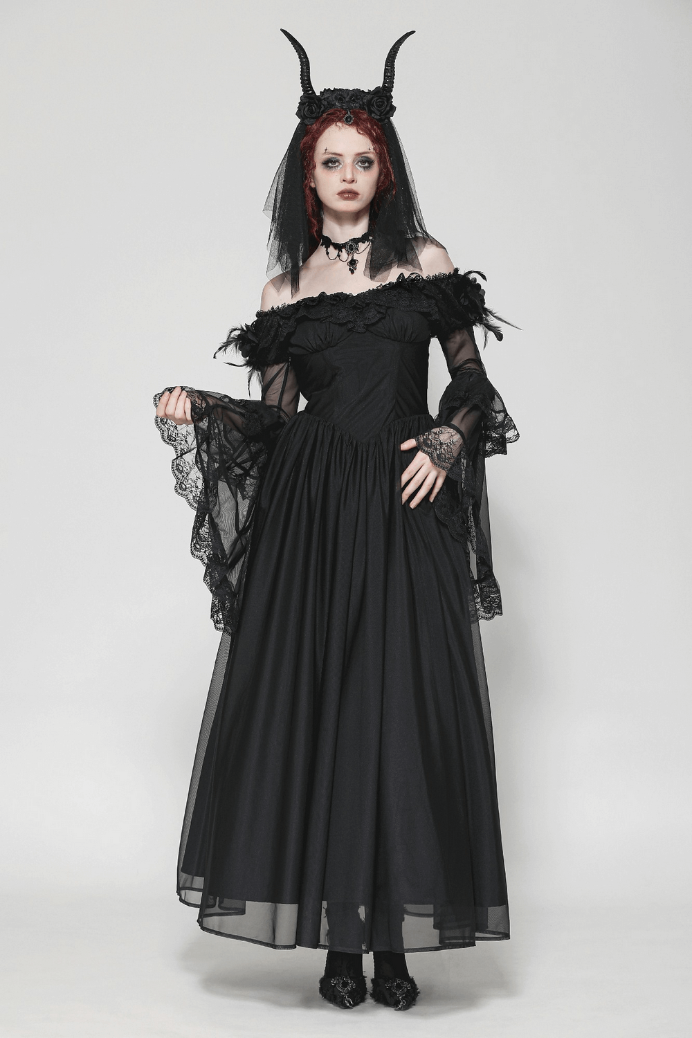 Vintage black Gothic dress with lace sleeves and dramatic details, perfect for themed events.