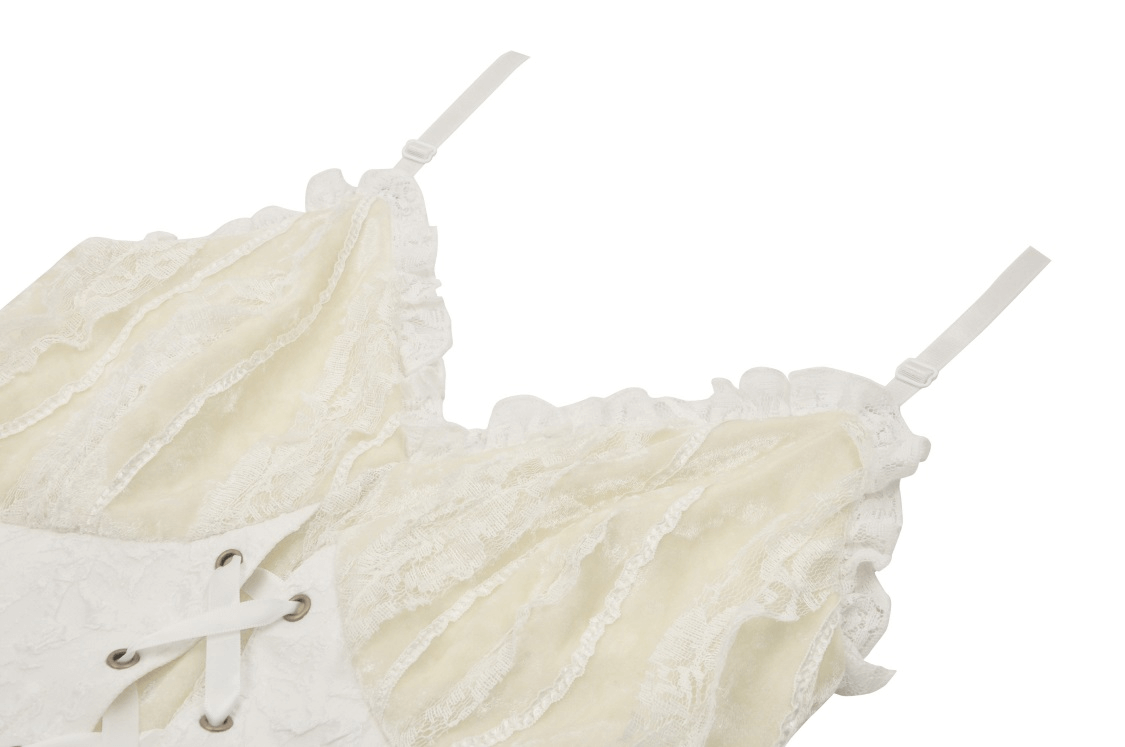 Close-up of vintage lace-up dress featuring delicate ruffles and intricate lace detailing.