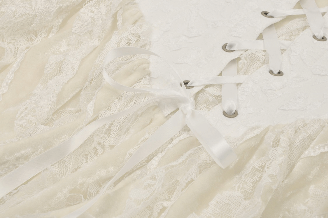 Close-up of vintage lace-up dress with ruffled layered skirt and intricate lace detailing in beige.