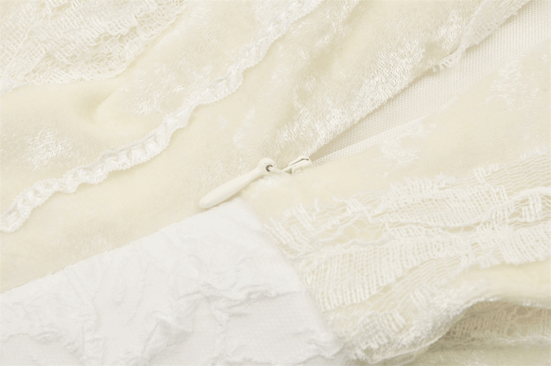 Close-up of vintage lace-up dress fabric with delicate lace detailing and zipper closure.