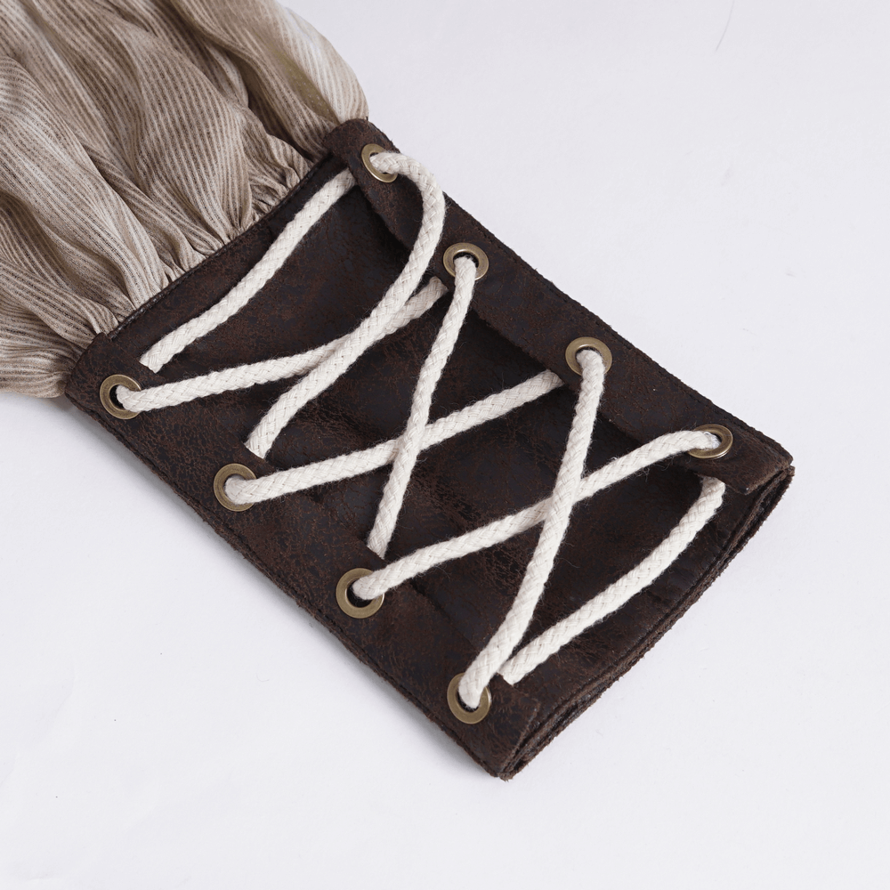 Close-up of a lace-up cuff in a vintage Gothic shirt, featuring textured fabric and intricate lacing detail.