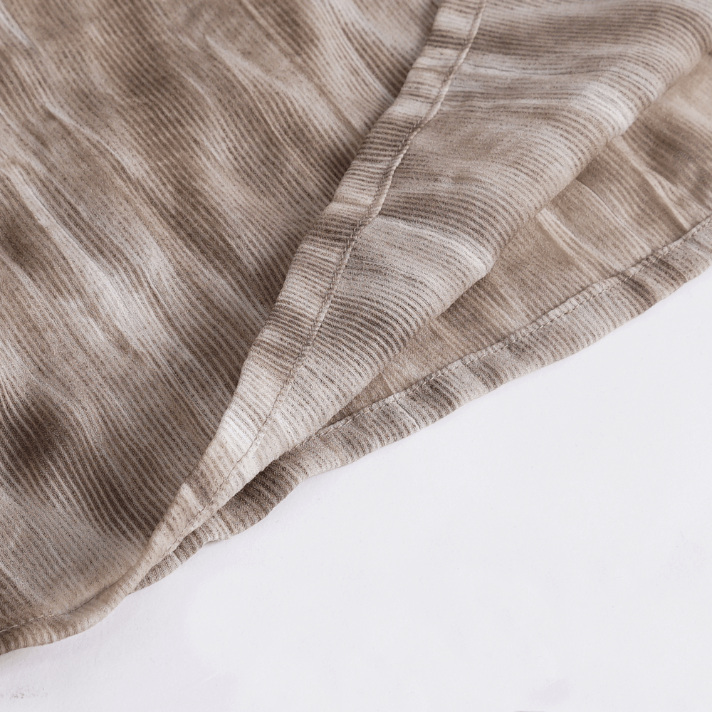 Close-up of textured fabric showcasing vintage lace-up detail for Gothic shirt with ruffled neck.