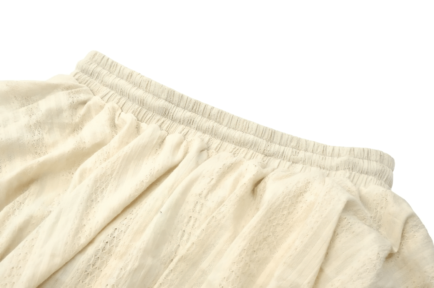 Close-up of vintage cream boho skirt with elastic waistband and elegant ruffles for a dreamy festival look.